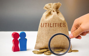 A money bag with the word Utilities and a family. The concept of saving money for the payment of utilities. The accumulation of money. A large debt. Electricity bill, heating. Debt repayment