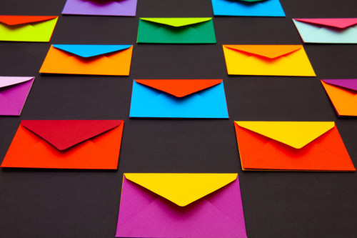 Composition with white and colored envelopes on the table.