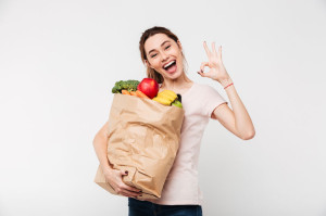 Close up portrait of a happy pretty girl holding bag