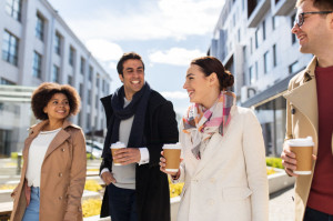 group of people or friends with coffee in city
