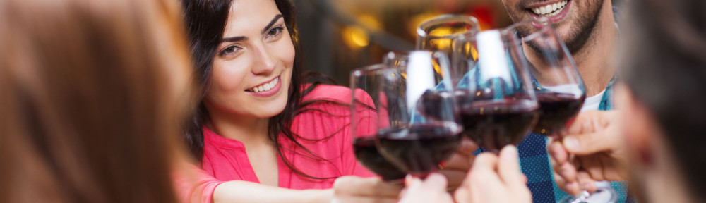 friends clinking glasses of wine at restaurant