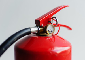 red fire extinguisher on white background