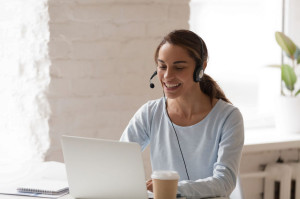 Beautiful smiling woman man working in headphones at office