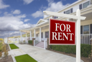 35643142 - red for rent real estate sign in front of beautiful house.