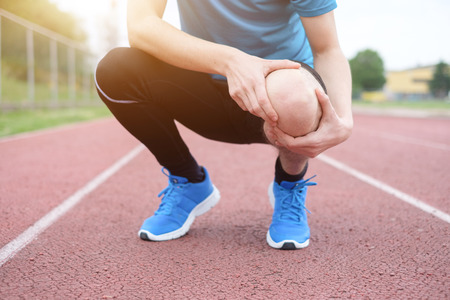 92990785 - running athlete feeling pain after having his knee injured