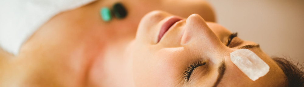 Young woman at crystal healing session in therapy room