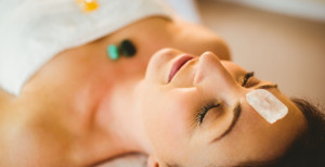 Young woman at crystal healing session in therapy room