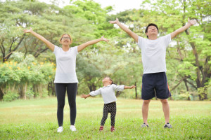 Happy Asian family workout at the park.