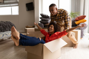 Side view of Happy African american couple having fun together in living room at home