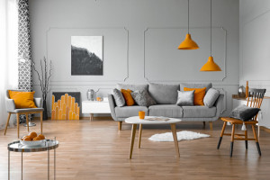 Spacious living room interior with coffee table, stylish chairs and grey comfortable sofa