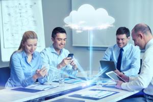 smiling business people with gadgets in office