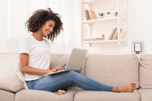 African-american woman working on laptop computer at home