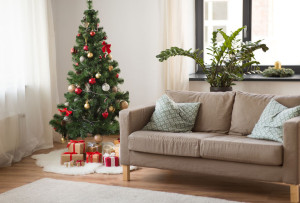 christmas tree, gifts and sofa at cozy home
