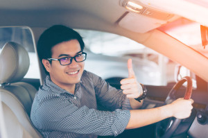 Portrait of asian happy handsome man showing thumbs up while dri