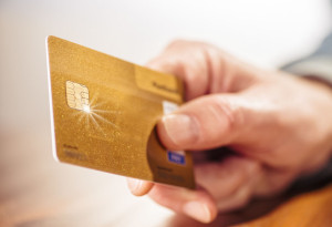 Hand with golden credit card