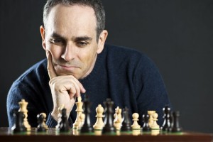 6811635 - chessboard with man thinking about chess strategy