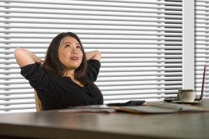 successful Asian Chinese business woman working confident at modern office computer desk in female businesswoman job smiling cheerful thoughful enjoying success