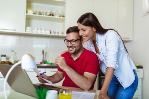 Young couple managing finances, reviewing their bank accounts us