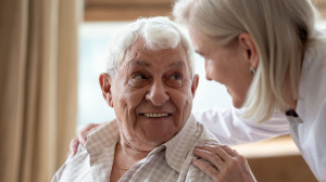 Cheerful elderly man looking at pleasant middle aged nurse.