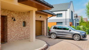 Shot of a car parked in front single-family detached house