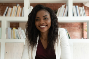 Smiling african business woman coach teacher hr looking at camera