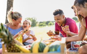 Cropped view of happy multiracial families having fun with kids