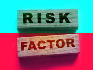 Risk factor words on wooden blocks. Healthcare or business startup causes of failure concept