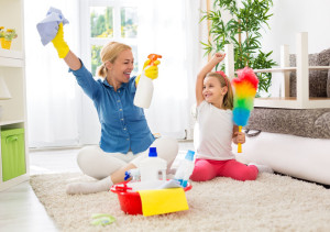 Cute mother and her daughter ready to cleaning room