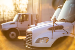 Middle rig semi Trucks standing at the gates of the warehouse fo