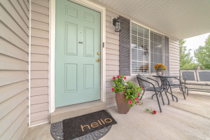 Front door of suburban home with welcome mat