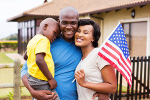 48851641 - beautiful african american family holding usa flag