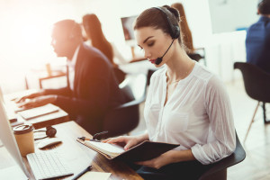 The girl is sitting at work in the call center.