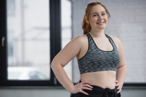 Curvy girl wearing sports top in gym