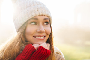 Close up of a cheerful pretty young girl wearing winter jacket