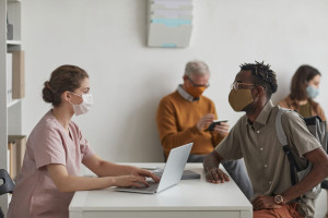 Female Doctor Consulting Patients