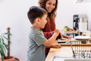 Mother and child making chocolate peanut cookies for quarantine