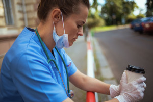 stressed modern medical doctor woman outdoors near hospital