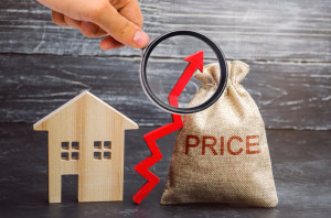 Bag with the money and the word Price and up arrow and wooden house. The increase in housing prices. Rising in fees for an apartment. The rise in property prices. The growth of utilities