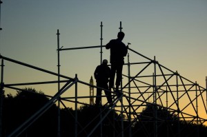 2392747 - silhouettes of two builders constructing something in the evening