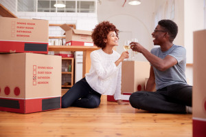 Couple Celebrating Moving Into New Home Drinking Champagne