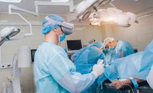 Doctor in a surgical room with virtual reality glasses