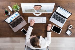 Businesswoman Videoconferencing With Senior Colleague