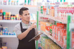 male shopkeeper working in a grocery store