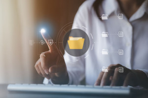 business man typing on a keyboard with holograms of digital docu