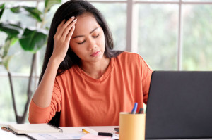 Work from home, Young asian woman struggle with laptop computer,