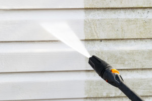 Cleaning service washing building facade with pressure water. Cl