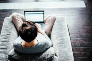 A woman works on a computer from home