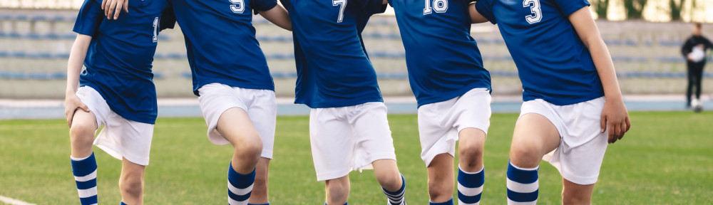 Sporty School Boys in Soccer Team. Group of Children in Football Jersey Sportswear Standing with Balls on Grass Pitch. Happy Smiling Kids in Sport Team