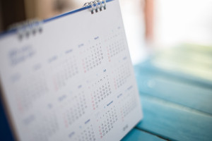 Blurred calendar page blue background.