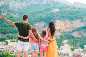 Summer holiday in Italy. Young woman in Positano village on the background, Amalfi Coast, Italy